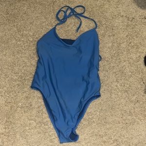 One piece open back blue Jolyn suit never worn